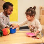Picture of a boy and girl playing with toys. Join Flight to help homeless children.