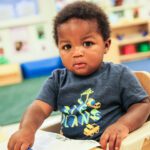 Picture of African American toddler. Join flight to help homeless children.